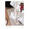 Camiseta de Manga Corta con Estampado de Letras de Pony de Dibujos Animados de Diseño Europeo para Mujer, Nueva Versátil de Cuello Redondo Primavera 2026