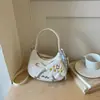 Bolsa de laço nicho Shuai Mi Jia para mulheres, nova bolsa crescente outono 2026, bolsa de bolinho texturizada para o dia a dia, bolsa transversal moderna