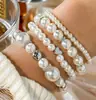Conjunto de Pulseiras Femininas de 4 Peças Estilo Nicho Transfronteiriço Europeu e Americano, Toque de Luxo Leve e de Alta Qualidade, Joias Empilháveis com Pérolas Artificiais em Formato de Coração