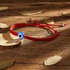 Venta caliente transfronteriza Nuevo Palma dos cuentas redondas ojos azules mal de ojo pulsera tejida con cuerda roja ajustable venta al por mayor de fábrica