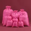 Bolsa de regalo navideña con cordón para guardar joyas, ideal para eventos transfronterizos.