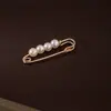 Colorido pasador de cintura con perlas y diamantes para ajustar la talla de la cintura de la ropa, accesorio de broche anti-exposición