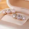 Popular Europeu e Americano Ouro Champagne e Diamante Branco Três Rodadas Cheias de Diamante Exquisite Cobre Banhado a Ouro Real Versátil Elegante Brincos Atacado