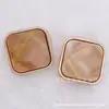 Al por mayor en stock hebilla de metal y resina de alta calidad botón cuadrado dorado con destellos finos botón para abrigo suéter cárdigan accesorios de moda