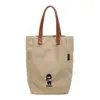 Bolsa de lona casual bordada con dibujos animados para mujer, nuevo estilo 2026, gran capacidad, adecuada para estudiantes, para ir al trabajo y versátil para el uso diario como bolso de hombro o bolso de mano