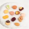 Juguetes de comida de simulación nueces pistachos cacahuetes castañas pegamento de crema DIY accesorios de resina Crocs cadena para teléfono pegatinas