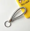 Llavero creativo llavero de cuerda de cuero cordón para llaves colgante de joyería cordón tejido fábrica de cuerda de cuero venta al por mayor