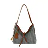 Bolso de mano tejido de alta gama estilo coreano para mujer Verano 2026 Gran capacidad Hueco Borla Versátil Bolso de hombro Cruzado