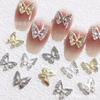Nueva joyería de uñas con mariposas rojas de Internet, accesorios de decoración de uñas con mariposas huecas tridimensionales de lujo con diamantes, venta al por mayor