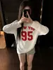 Camiseta de manga larga con hombros descubiertos estilo retro americano para mujer, diseño único, corte holgado, hombros descubiertos, top de moda