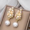 Corea del Sur colección de pendientes de perlas de alta calidad aguja de plata retro pequeño aroma diamante de color ocho puntas de estrella pendientes pendientes al por mayor