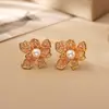Pendientes de botón de flor de perla hueca de alta gama, a la moda, lujo ligero, temperamento, joyería de oreja exquisita, sentido del diseño, accesorios de diosa