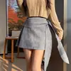Falda corta de gamuza de color sólido para mujer, estilo nicho adelgazante con pajarita, para ocultar el abdomen y realzar las caderas