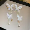 Pendientes de borla de flor de concha blanca transfronterizos europeos y americanos con perlas, pendientes de estilo de corte francés, pendientes ligeros y lujosos con un toque de alta gama