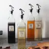Venta al por mayor de fábrica botella de aceite de vidrio transparente olla de aceite botella de aceite de oliva botella de aceite vinagre con boquilla sub-embotellado