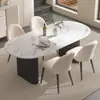 Mesa de comedor de color crema, moderna y lujosa con tapa de piedra para uso doméstico, con un diseño moderno y minimalista de forma ovalada negra, adecuada para comedores