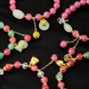 Pulseira Série Guofeng Mais Vendida Internacionalmente Cristal Rosa Diamante Colorido Bolsa da Sorte Fivela Ping An Lótus Rosa Bract Pulseira Artesanal para Mulheres