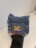 Bolso de mezclilla lavado bordado con gato lindo, nuevo, transfronterizo 2026, para mujer, versátil, con múltiples bolsillos, de hombro y cruzado