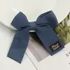 Accesorio para el pelo de clip con lazo de tela con logo y correa de espiga estilo coreano, accesorio para el pelo, juguete para mascotas, ropa de muñeca, accesorios para funda de teléfono