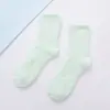 Color caramelo 21 colores color sólido Calcetines de tubo planos cálidos para mujer forro polar de coral calcetines para el suelo del hogar calcetines de medio terciopelo venta al por mayor