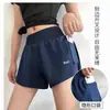 Nuevos shorts deportivos transfronterizos, diseño falso de dos piezas, secado rápido, pantalones de yoga anti-exposición con bolsillos, shorts de fitness para mujer