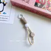 Pulseira criativa corda rosto sorridente chaveiro corda corda de celular japonesa anti-queda câmera celular celular feminino moderno corda trançada