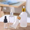 Botella de aceite de esencia transparente vidrio esmerilado líquido de esencia botella para rellenar botella con gotero de cabeza de goma muestra cosmética botella vacía venta al por mayor