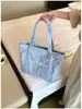 Bolsa de ombro única feminina design de nicho senso de estilo couro macio bolsa feminina grande capacidade para o dia a dia temperamento bolsa tote simples feminina transfronteiriça