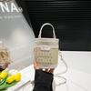 Bolsa de Ombro Transversal Balde Texturizada Verão 2026 Novo Estilo Elegante Patchwork Tecida Tendência Design de Letras Fashion Versátil para o Dia a Dia