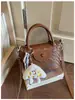Bolsa de mão tecida de nicho de alta qualidade estilo coreano para mulheres, nova moda 2026 versátil para o dia a dia, de ombro e transversal