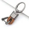 Chaveiro de carro de corda de couro trançado novo do fabricante, simples para homens, liga de zinco, padrão de pendurar na cintura, fivela de cabeça grande, cordão