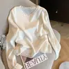 Camiseta Off-White Decotada Gola Redonda Manga Longa para Mulheres 2025 Outono e Inverno Nova Nicho Chic Manga Longa Top Tricotado Macio Encerado