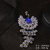 Broche de pavo real anti-luz transfronterizo entre Europa y Estados Unidos, broche, accesorios de ropa de diamantes de imitación de alta calidad, broche vintage de fénix