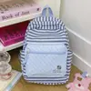 Mochila de rayas estilo coreano transfronteriza, casual, simple, versátil, mochila escolar de nicho para estudiantes de secundaria, preparatoria y universidad