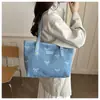 Bolsa de ombro feminina transfronteiriça com laço doce 2026 de lona jeans casual moda grande capacidade sob o braço tote