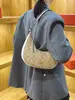 Bolso de mujer estilo vintage modelo nuevo 2026, versátil para el trabajo, bolso de hombro de media luna a la moda y casual, bolso de hombro popular con forma de cuerno