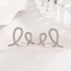 Pendientes de diamantes en forma de rollo de crema para mujer, ligeros, lujosos, exquisitos, de diseño nicho, de alta gama, accesorios únicos para las orejas de celebridades de Internet.