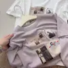2026 Nova Moda Estilo Coreano Camiseta de Gola Redonda Manga Curta Fashion para Mulheres, Top Versátil Soltinho Emagrecedor, Top Branco de Manga Curta Estampado para Mulheres