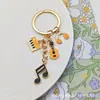 Chaveiro Criativo Doce de Guitarra em Liga Metálica Venda Quente Transfronteiriça Pingente de Bolsa de Música da Moda Pingente de Fone de Ouvido para Meninas
