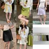¡Moda de Viaje Adelgazante Estilo Coreano Guangzhou Ruiyi! Falda Versátil Casual de Color Sólido A-Line de Satén de Acetato para Mujer Verano 2026