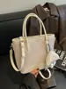 Bolso de mujer de nicho de alta gama transfronterizo 2026 nueva moda versión coreana bolso cruzado, bolso cubo de mano simple súper popular