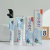 El puesto vende pasta de dientes efervescente sabor a fruta arándano maracuyá pasta de dientes pequeña fresca 110G180G venta al por mayor de fábrica