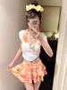Traje de baño de dos piezas nuevo para 2026, con cuello halter y manga corta para mujer, que presenta una falda tipo pastel degradada, perfecta para un look dulce y casual en la playa, spa o vacaciones.
