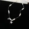 Colar Pérola Estrela Zircônia Céu Estrelado, um colar delicado e elegante com um toque luxuoso, perfeito para combinar com suéteres, exalando uma aura suave e refinada