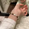 Pulsera de hilo con cuentas redondas y cuentas de ojo de tigre Maillard retro de nicho europeo y americano, corazón esmerilado, pulsera con sentido de diseño para mujer