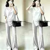 Conjunto de duas peças de moda gestante estilo coreano para o verão, camiseta de cor sólida irregular com cordão, calça flare de cintura alta plus size que cobre a barriga e emagrece