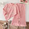 Conjunto de top irregular de malha escovada espessa estilo europeu e americano para meninas 2026 + calça pantalona casual