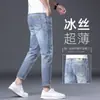 Jeans masculinos europeus e americanos da moda, etiqueta de couro de alta qualidade da moda, novas calças casuais skinny justas e elásticas