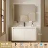 Tocador de baño engrosado y ahorrador de espacio con diseño en color crema, que cuenta con un lavabo redondeado, lavabo cerámico integrado y un lavabo de una sola pieza.