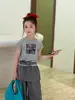 Camiseta Infantil Hua Yu Xun 2026 Verão Nova Gola Redonda Cropped Estampa de Desenho Manga Curta Estilo Coreano Casual